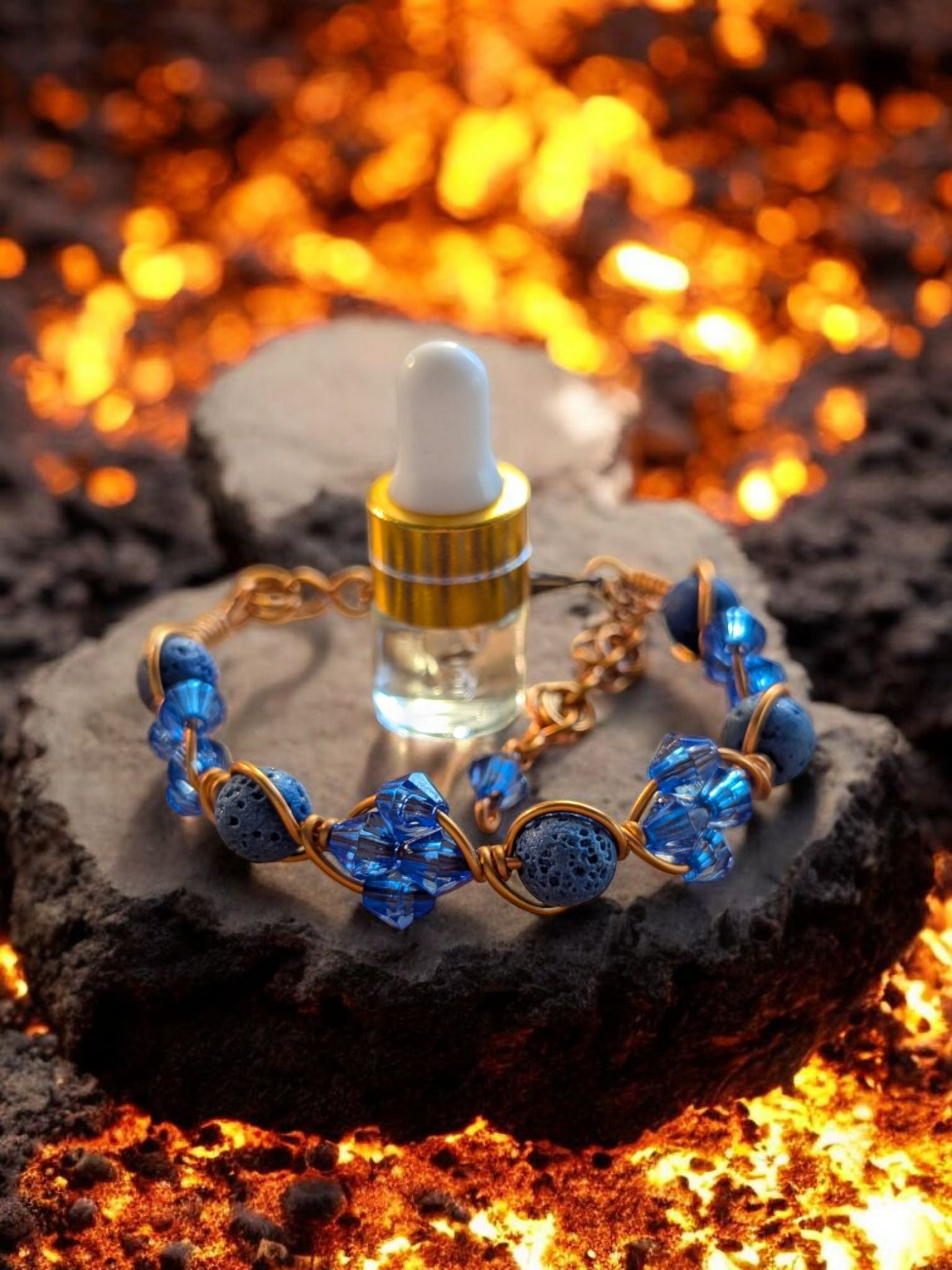 Handcrafted adjustable cuff diffuser bracelet with blue lava beads and blue resin bicone accents wrapped in copper hypoallergenic wire, displayed on a rock above glowing lava.